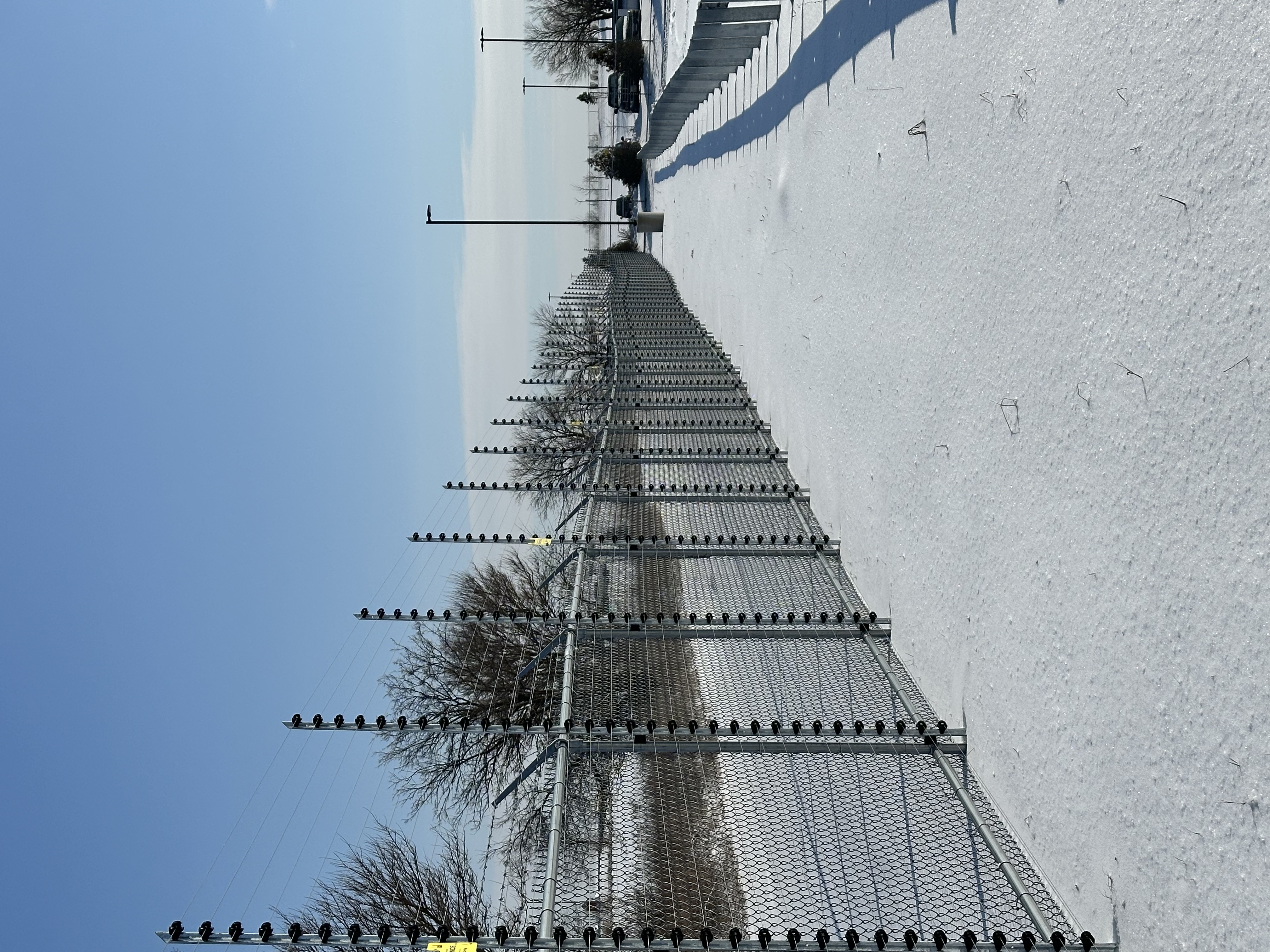 Snow-covered security fence